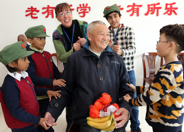 中外师生敬老院里学雷锋